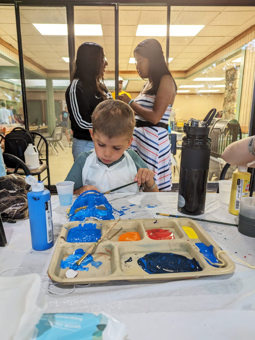 A young boy does crafts at summer day camp at the Fowler Center