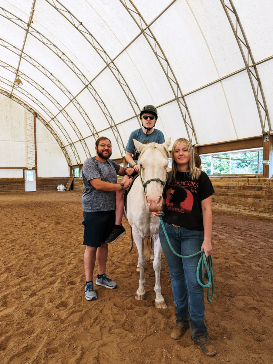 a young man is riding a horse in the equestrian center at the Fowler Center