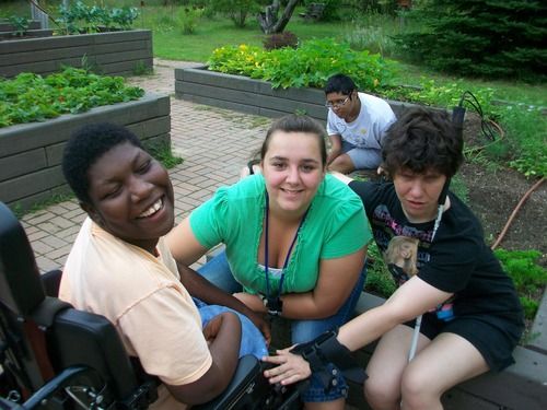 A group of campers with their counsellor spend time in the garden at The Fowler Center
